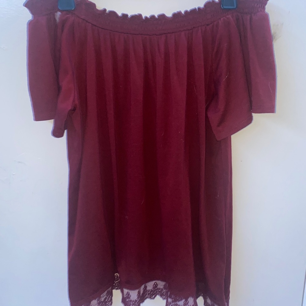 Off the shoulder maroon shirt.